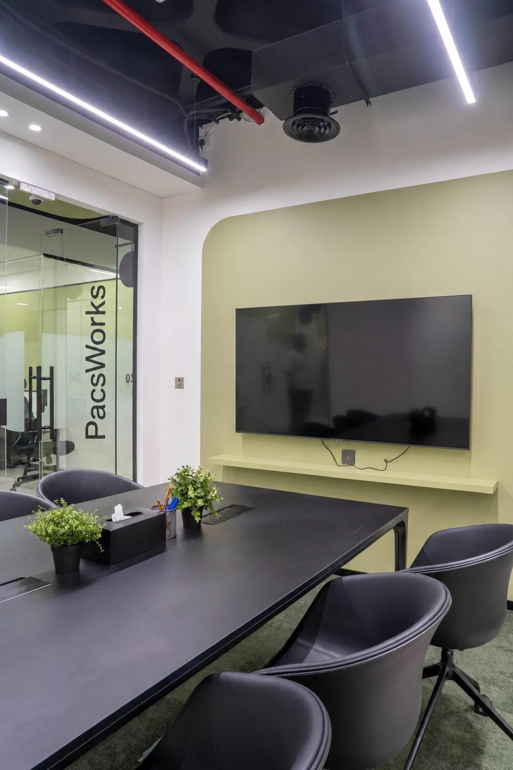 Meeting room at the PacsWorks office in Dubai Healthcare City, with the PacsWorks name on the glass door